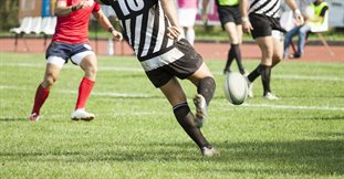 Rugby-player-kicking-ball